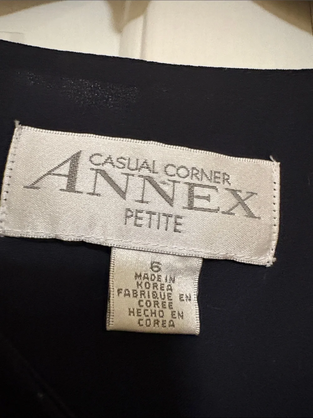 Casual Corner Annex Petite ivory label on black fabric